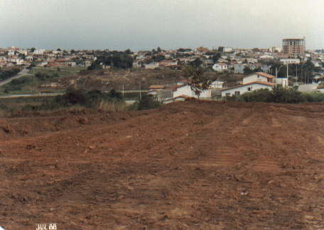 Terreno limpo sem construção, com casas bem ao fundo